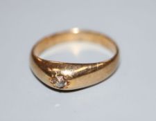 A yellow metal and gypsy set solitaire old cut diamond ring, size Q, gross 4.9 grams.