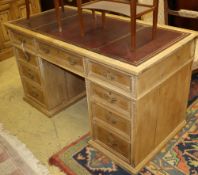 An early 20th century pine pedestal desk, W.130cm, D.63cm, H.73cmCONDITION: Has a replaced