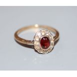 A 1970's 9ct gold, garnet and white sapphire? set oval cluster ring, size L, gross 1.6 grams.