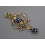 An early 20th century yellow metal, two stone sapphire and three (ex 4) white stone set drop