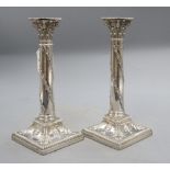 A pair of late Victorian silver candlesticks with acorn and urn decoration, Thomas Bradbury &
