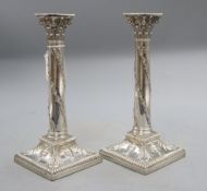 A pair of late Victorian silver candlesticks with acorn and urn decoration, Thomas Bradbury &