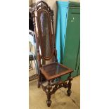 A Carolean-style carved walnut caned high back chair