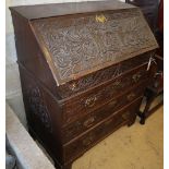 An 18th century oak bureau, later carved, W.86cm, D.50cm, H.105cm