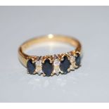 A modern 18ct gold, sapphire and diamond set half hoop ring, size L, gross 3.3 grams.