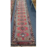 A North West Persian red ground runner, 390 x 90cm