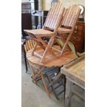 A circular teak folding garden table and four chairs, table 90cm diameter