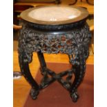 A 19th century Chinese marble topped carved hardwood jardiniere stand, diameter 44cm, H.53cm