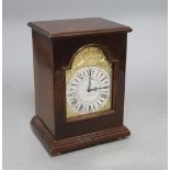 A 'Silver Jubilee' mahogany-cased mantel clock by Charles Frodsham, having arched gilt dial with