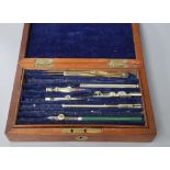 A mahogany box containing drawing instruments