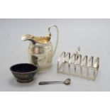 An Edwardian silver milk jug, 13.3cm, a silver toast rack, silver salt and silver condiment spoon,