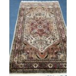 An Eastern ivory ground silk rug, 200 x 115cm