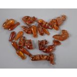 A collection of amber beads, carved as animals, (part of a necklace), largest 31mm, gross 33 grams.