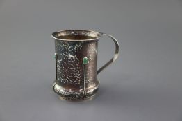 An Edwardian Arts & Crafts planished silver and turquoise cabochon set mug, by Albert Edward