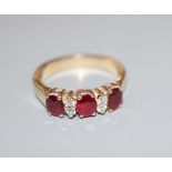 A modern 18ct, ruby and diamond set dress ring, size M, gross 5.6 grams.