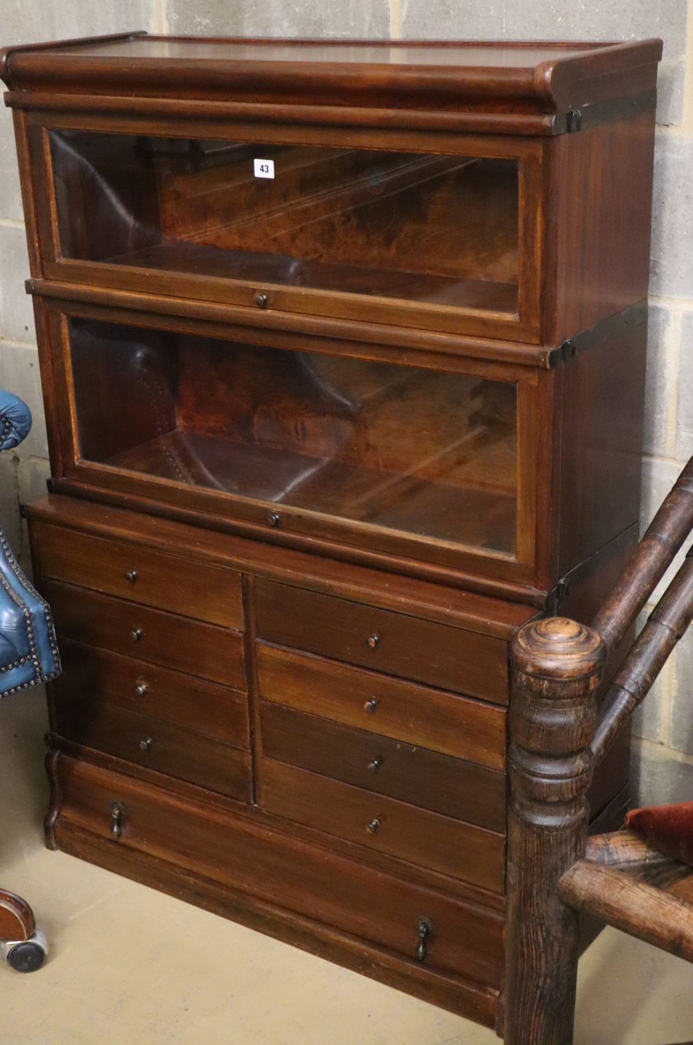 A Globe Wernicke mahogany two section bookcase with eight drawer base section, on plinth base, W.