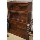 A Globe Wernicke mahogany two section bookcase with eight drawer base section, on plinth base, W.