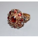 A 19th century 18ct, garnet and rose cut diamond set oval cluster ring, size O, gross 7 grams,