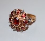 A 19th century 18ct, garnet and rose cut diamond set oval cluster ring, size O, gross 7 grams,