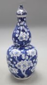 A Chinese blue and white double gourd vase and cover, height 26cmCONDITION: Large chip to the