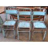 A set of seven vintage painted metal stacking chairs