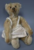 A vintage Steiff c1908 with button in ear, some hair loss generally, height 20cm