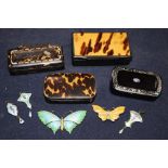 Four 19th century papier mache snuff boxes, two enamelled silver butterfly brooches and three