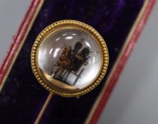 A cased Victorian yellow metal and Essex crystal 'coaching scene' stick pin, 89mm, gross 9.2 grams.