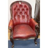 A Victorian red buttoned leather upholstered spoonback armchair