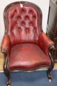 A Victorian red buttoned leather upholstered spoonback armchair