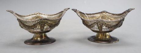 A pair of late Victorian pierced silver oval bonbon baskets by Charles Stuart Harris, London,