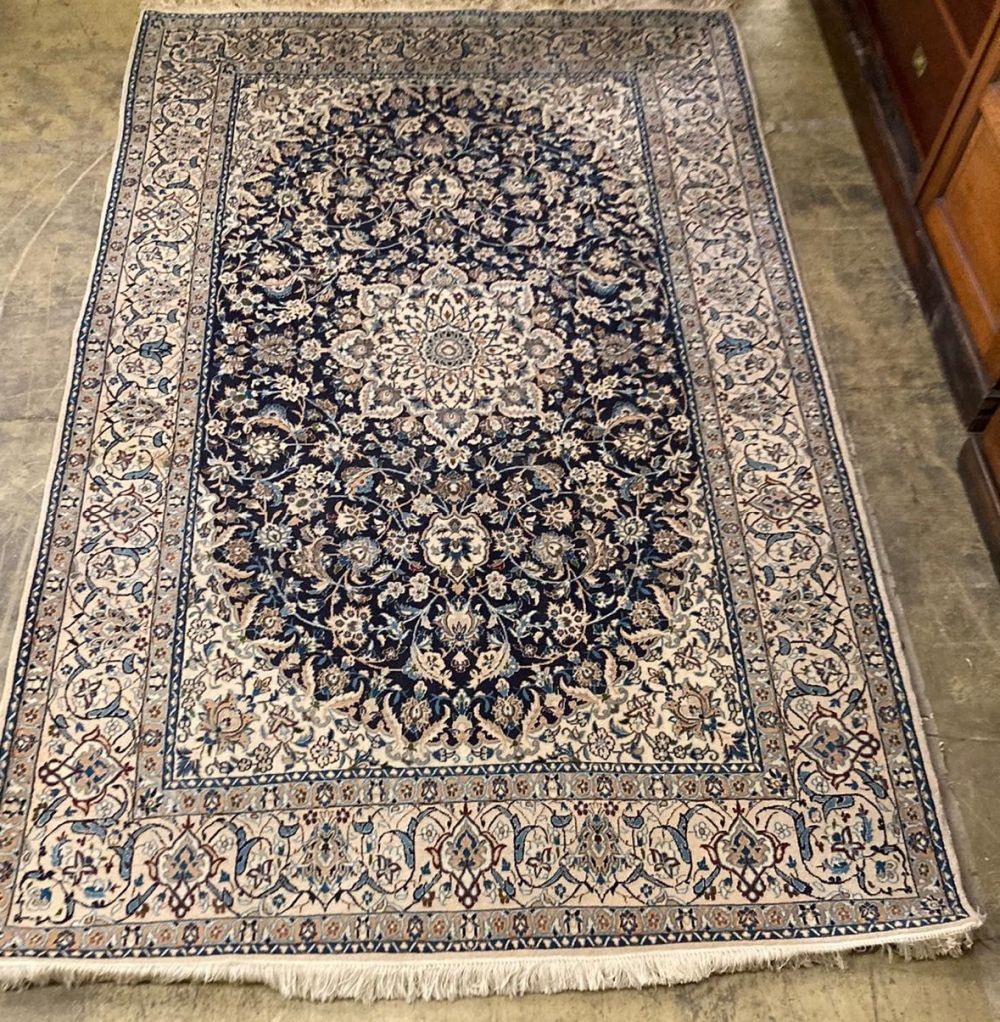 A Tabriz style blue and ivory ground rug, 270 x 176cm