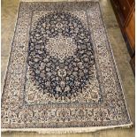 A Tabriz style blue and ivory ground rug, 270 x 176cm