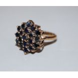 A modern 9ct gold and sapphire cluster dress ring, size M, gross 5.2 grams.