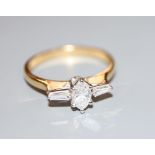 A modern 18ct gold, marquise and trapeze cut diamond set three stone dress ring, size Q, gross 3.1