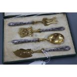 A cased early 20th century French parcel gilt white metal four piece serving set, longest 18cm,