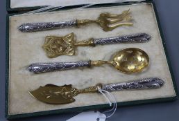 A cased early 20th century French parcel gilt white metal four piece serving set, longest 18cm,