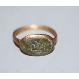 An antique gilt metal and oval bronze plaque set ring, size P.CONDITION: Visible verdigris to top of