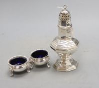 A George V silver sugar caster, London, 1922, 21cm and two silver bun salts, gross 12oz.