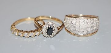 Two modern 9ct gold and diamond set dress rings and a 9ct gold sapphire and diamond cluster ring,