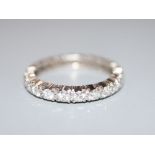 A white metal and diamond set full eternity ring, size M, gross 3.3 grams.CONDITION: One of the