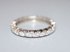 A white metal and diamond set full eternity ring, size M, gross 3.3 grams.CONDITION: One of the