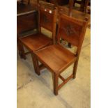 A pair of carved oak hall chairs