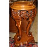 An Indian style carved oak jardiniere stand, H.82cm