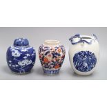 A blue and white Chinese dragon jar, an Imari jar and a blue and white lidded Prunus jar, tallest