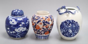 A blue and white Chinese dragon jar, an Imari jar and a blue and white lidded Prunus jar, tallest