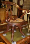 A Victorian oak cane seat revolving desk chair, a.f.