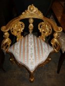 An 18th century style corner giltwood elbow chair