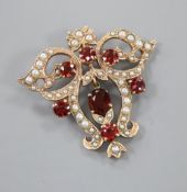 A Victorian style 9ct gold, garnet and seed pearl set openwork scrolling drop pendant, 40mm, gross 9