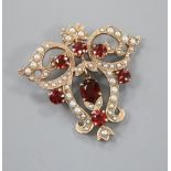 A Victorian style 9ct gold, garnet and seed pearl set openwork scrolling drop pendant, 40mm, gross 9